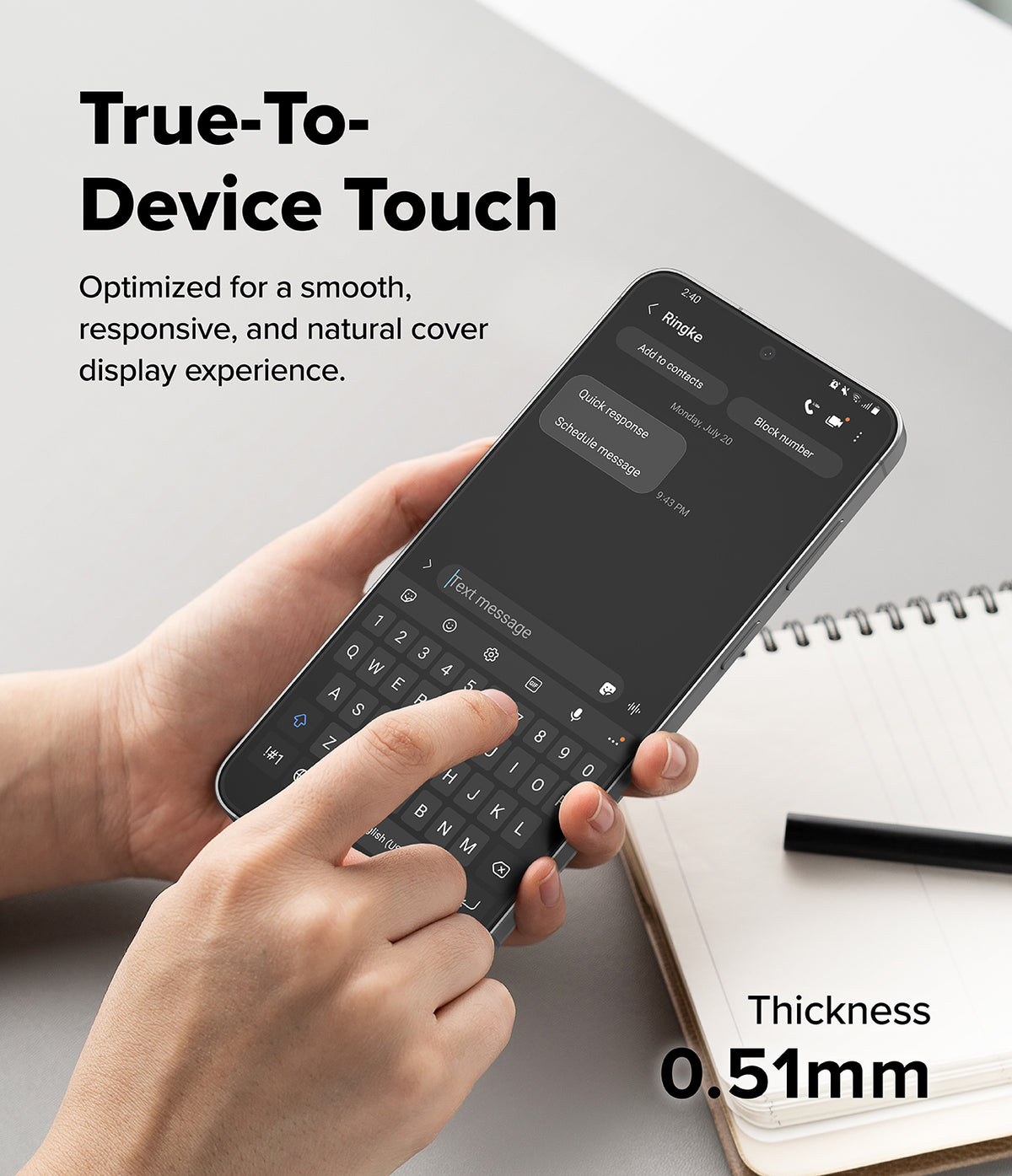 Galaxy S26 FE Screen Protector | Easy Slide Tempered Glass (2P) - A hand holds a smartphone showing a keyboard cover overlay, with text reading 'True-To-Device Touch' and 'Thickness 0.51mm' on a light desk background with an open notebook and pen.