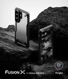 Galaxy S26 Ultra Case | Fusion-X - Two Galaxy S26 Ultra phones in Fusion-X cases resting on dark, jagged volcanic rock.