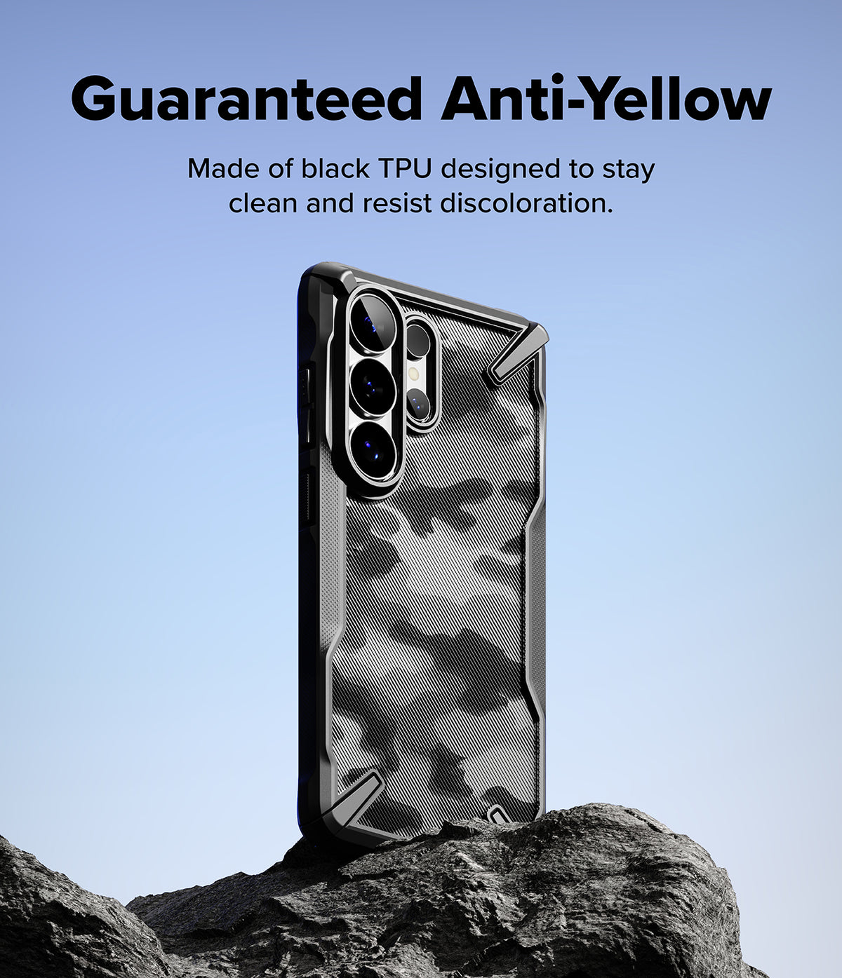 Galaxy S26 Ultra Case | Fusion-X - Black patterned phone case standing on a rock against a clear blue sky.