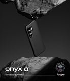 Galaxy S26 Ultra Case | Onyx α - Black phone case floating between two jagged, textured rock formations against a dark background.