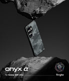 Galaxy S26 Ultra Case | Onyx α - Camouflage phone case suspended between two jagged rocks against a dark background.