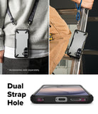 Galaxy S26 Plus Case | Fusion-X - Phone in protective case hanging from straps, showing dual strap holes at the base.