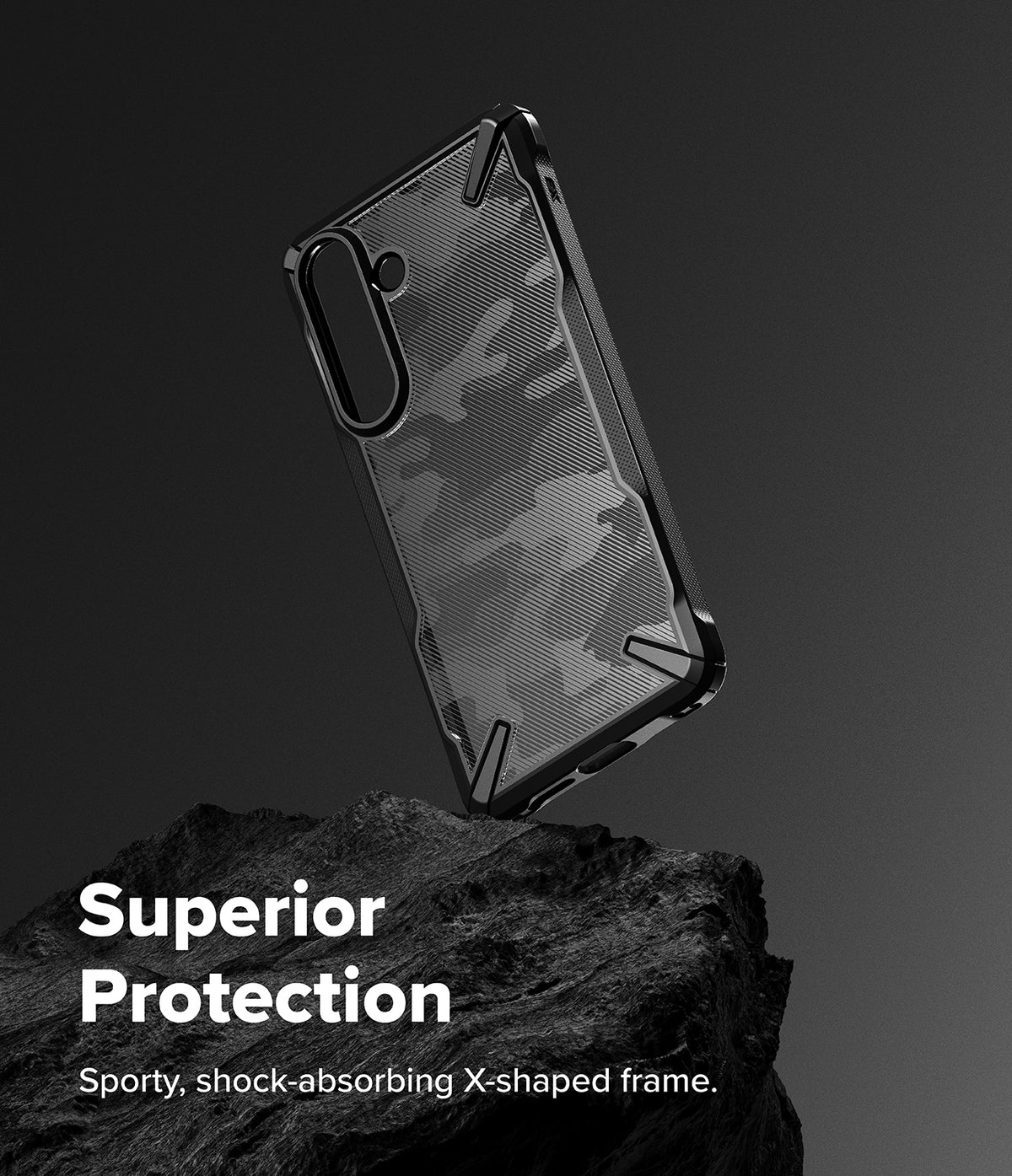 Galaxy S26 Plus Case | Fusion-X - Black camouflage phone case with a rugged X-shaped frame resting on a dark rock.