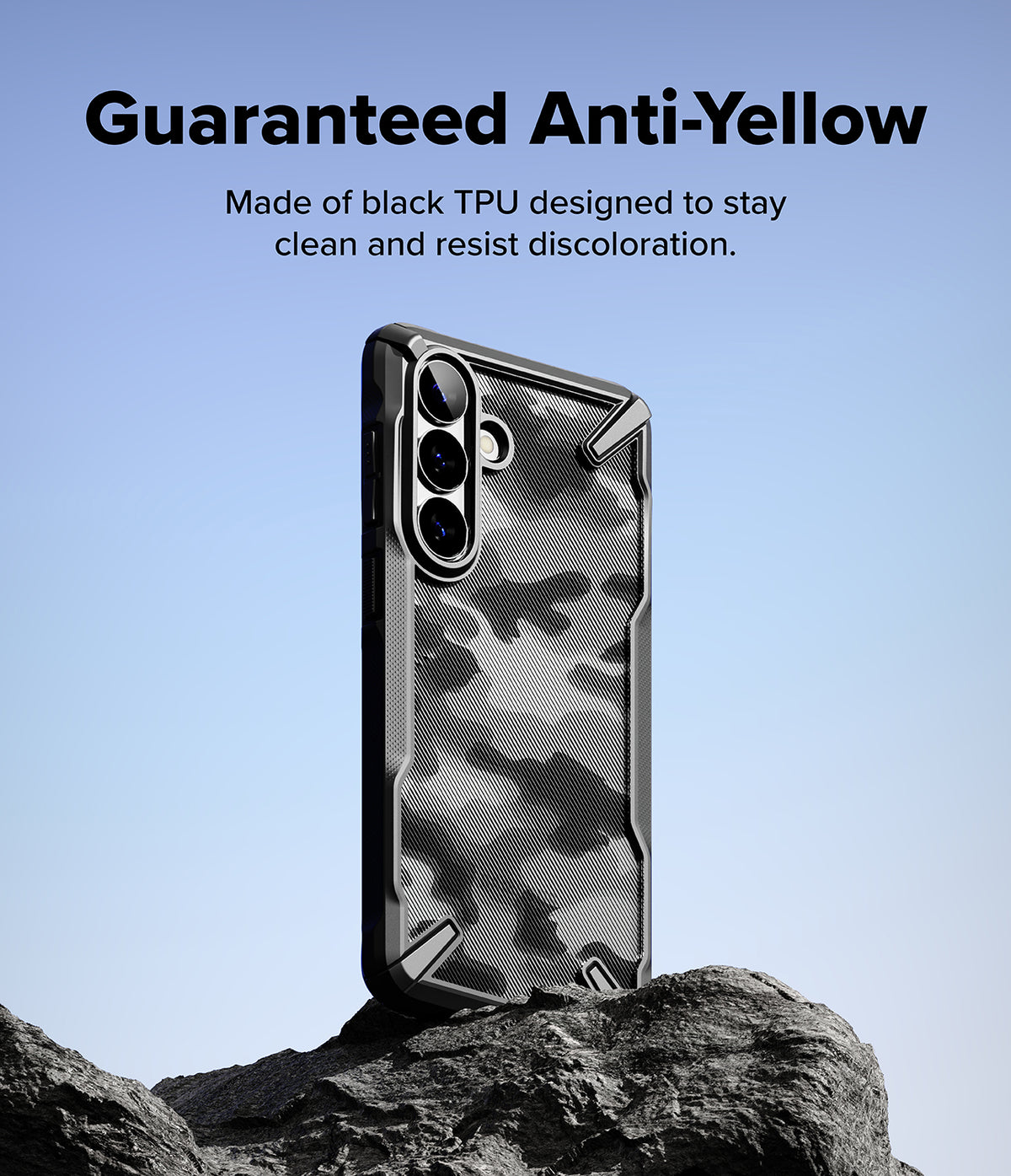 Galaxy S26 Plus Case | Fusion-X - Black patterned phone case standing on a rock against a blue sky background.