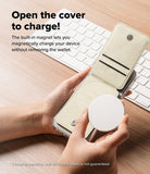 Card Holder | Slide Grip Wallet Magnetic - Hands holding a phone with an open magnetic wallet while attaching a charger.