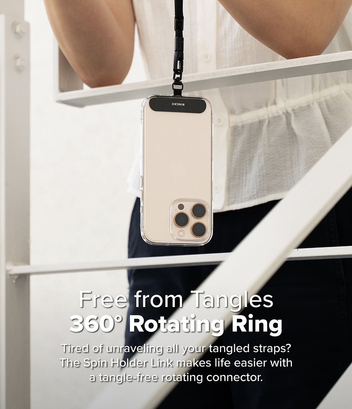 Holder Link Spin - Smartphone in a clear case with a 360-degree rotating strap connector hanging from a black lanyard.