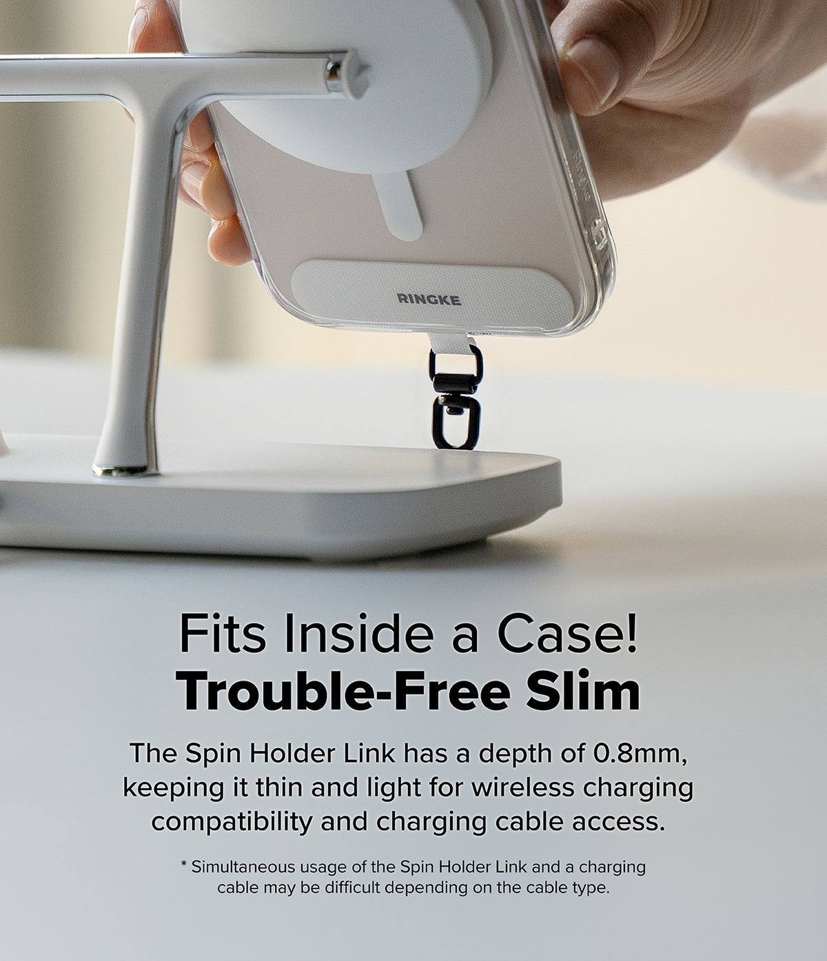 Holder Link Spin - A slim phone tether attached to a case, shown being placed on a wireless charging stand.