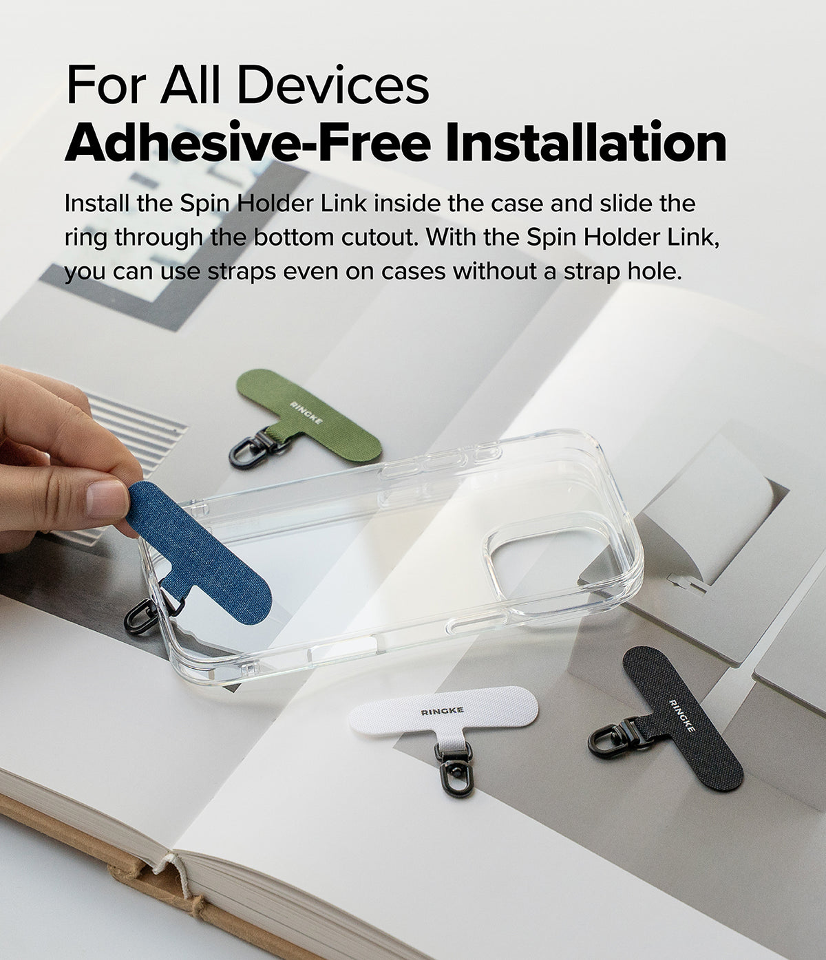 Holder Link Spin - Hand placing a blue adhesive-free phone strap anchor into a clear phone case with other color options nearby.