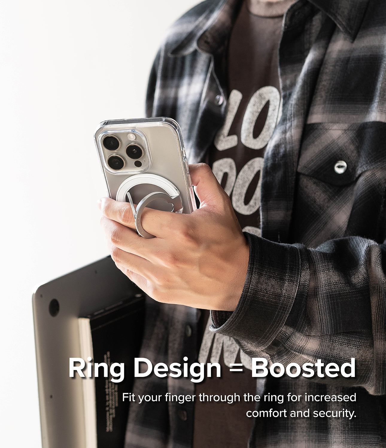 Ringke Smart Ring Magnetic - A hand holding a smartphone with a magnetic ring grip attached to the back for secure handling.