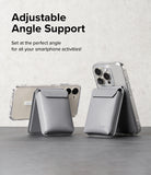 Card Holder | Stand Pocket Magnetic - Two grey magnetic card holders attached to smartphones, propped up as stands.