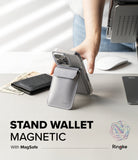Card Holder | Stand Wallet Magnetic - A grey magnetic wallet attached to a phone, propped up as a stand on a desk.