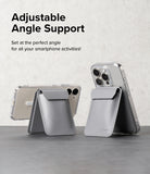 Card Holder | Stand Wallet Magnetic - Two grey magnetic wallets attached to smartphones, propped up as stands on a table.