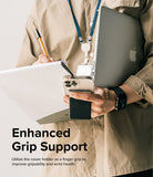 Card Holder | Stand Slot - Person holding a phone with a black card holder grip while carrying a laptop and notepad.