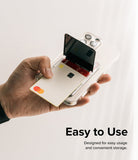 Card Holder | Stand Slot - Hand holding a clear phone case with a flip-out card holder slot containing credit cards.