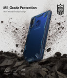 Galaxy A20 Case | Fusion-X - Blue rugged phone case standing on rocky ground amidst a dust explosion with mil-grade text.