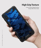 Galaxy A50 Case | Fusion-X - Hand holding a phone with a blue camo-patterned case featuring a rugged black bumper frame.