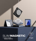 Galaxy Z Flip 7 FE Case | Slim Magnetic - Magnetic phone cases for Galaxy Z Flip stacked on a pedestal with a charger.