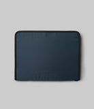 Pad Pouch | Smart Zip Pouch - A rectangular navy blue zippered pouch with black trim against a light gray background.