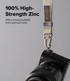 Holder Link Tactical Webbing Hand Strap - Beige tactical strap with a zinc alloy carabiner attached to a black camera.