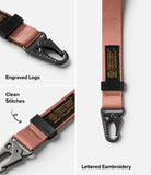 Holder Link Tactical Webbing Hand Strap - Dusty rose webbing strap with black metal carabiner, branded tag, and stitching.