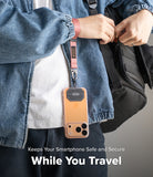 Holder Link Tactical Webbing Hand Strap - A person wearing a denim jacket with a pink tactical strap attached to a phone.