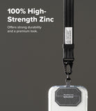 Holder Link Tactical Webbing Hand Strap - A close-up of a black fabric lanyard with a metal clasp attached to a clear phone case, shown against a dark gray background with promotional text reading '100% High-Strength Zinc'.