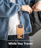 Holder Link Tactical Webbing Hand Strap - A person wearing a denim jacket uses a tactical webbing strap to carry a phone.