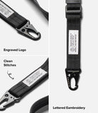 Holder Link Tactical Webbing Lanyard Strap - A black webbed strap with a black metal carabiner and a white embroidered label. The image is a multi-panel feature showcase showing close-ups of the engraved logo, clean stitches, and lettered embroidery, with text labels on a light gray background.