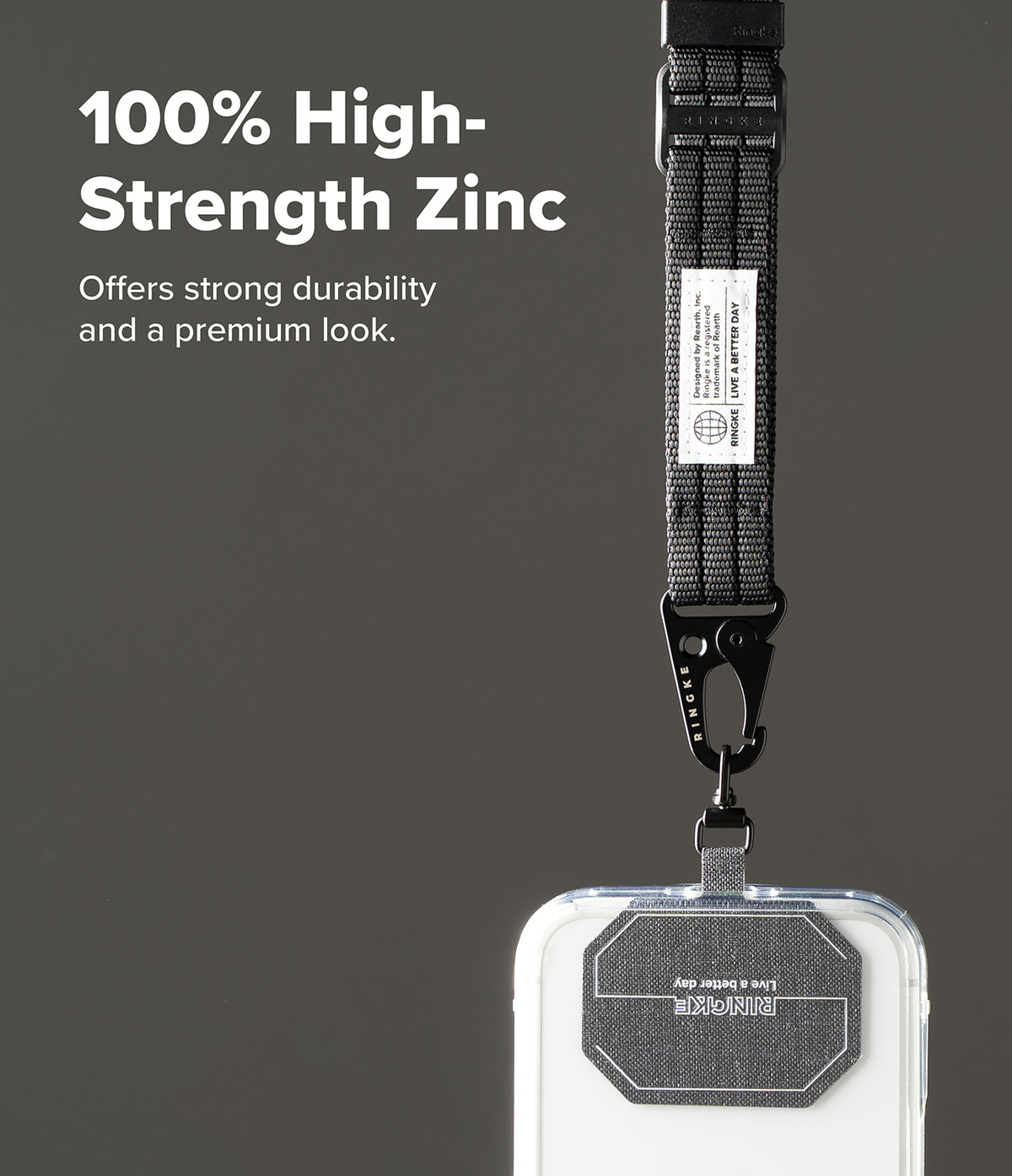 Holder Link Tactical Webbing Lanyard Strap - A clear phone case with a black textured strap and metal clasp, shown against a dark gray background with promotional text reading '100% High-Strength Zinc'.