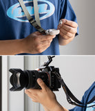 Holder Link Tactical Webbing Lanyard Strap - Person wearing a tactical lanyard holding earbuds and a Sony camera.