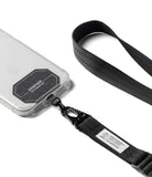 Holder Link Tactical Webbing Lanyard Strap - A black nylon phone lanyard strap with a metal carabiner clip attached to a clear smartphone case, shown on a clean white background.