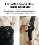 Mini Pouch | Tambourine Bag - Black circular pouch attached to a belt loop and a backpack strap using a metal carabiner.