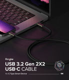 Ringke USB 3.2 Gen 2x2 USB-C Charging Cable - Black braided USB-C cable connecting a smartphone to a laptop.