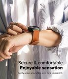 Watch Lug 24mm | Leather One Basic Bold - Person wearing a black smartwatch with a tan leather strap on their wrist.