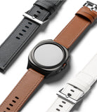 Watch Lug 24mm | Leather One Basic Bold - A black smartwatch with a brown leather strap flanked by black and white straps.