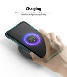 Mi 10 / 10 Pro Case | Fusion-X - A hand places a smartphone in a protective case onto a wireless charging pad showing 100% charge.