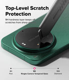 Xiaomi 17 Ultra | Camera Glass (2P) - A utility knife blade scrapes a 9H tempered glass protector on a green phone camera.