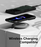 Xiaomi 14 Case | Fusion-X - Black phone case on a wireless charging pad showing a 35% battery charge icon on the screen.