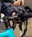 Quick & Go | Lever Mount Add-on - Hands using a tool to tighten a black lever mount onto a bicycle handlebar stem.