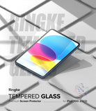 Tempered Glass | iPad - iPad with a clear screen protector applied, surrounded by multiple blank tablet outlines on a gray surface.