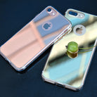 iPhone 7 Plus Case | Mirror - Two reflective iPhone cases in rose gold and silver, with a small green fruit resting on one.