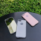 iPhone 7 Plus Case | Mirror - Three iPhone 7 Plus cases in mirror, clear, and rose gold finishes on a black table outdoors.