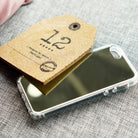 iPhone SE / 5s / 5 Case | Mirror - A reflective mirror phone case resting under a cork tag labeled with the number 12.