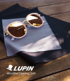 Microfiber Cleaning Cloth [Small] - Pink-rimmed sunglasses resting on a gray branded microfiber cloth atop a black cloth.