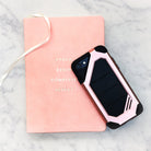iPhone 8 / 7 Case | Max - A rugged pink and black phone case resting on a pink notebook with gold text on a marble surface.