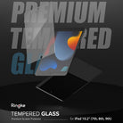 Tempered Glass | iPad - A transparent screen protector being applied to an iPad against a dark background with bold text.