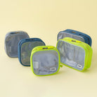 Travel Organizer Pouch - Four colorful mesh travel pouches in various sizes arranged on a light yellow background.