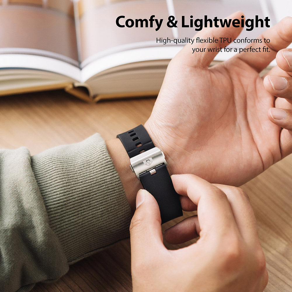 Galaxy Watch (46mm) | Rubber One Prime Band - Person adjusting a black ribbed rubber watch band with a metal clasp.