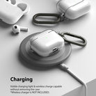 AirPods 3 Case | Hinge - Clear AirPods 3 case with carabiner charging wirelessly on a grey circular pad.