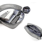 Travel Organizer Pouch - Grey zippered pouch containing electronics, cables, and SD cards with internal mesh pockets.